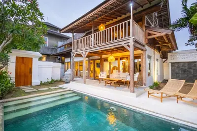 an exterior view of a house with a swimming pool at Villa Vintage 2 in Canggu
