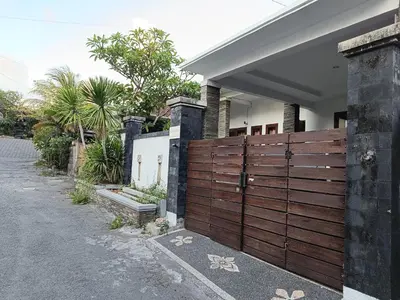 a wooden fence in front of a house at Casa Dijaweqo in Jimbaran