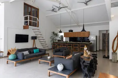 a living room with two couches and a staircase at Villa Malya 5 bedrooms Seminyak in Seminyak