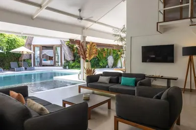 a living room with a couch and a swimming pool at Villa Malya 5 bedrooms Seminyak in Seminyak