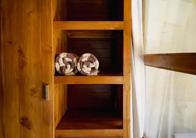 two donuts are sitting in a wooden cabinet at Bale Bali Batubelig by ARM Hospitality in Canggu