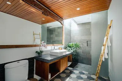 a bathroom with a sink and a toilet at Bale Bali Batubelig by ARM Hospitality in Canggu