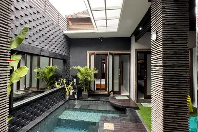 a house with a swimming pool in front of it at MOOvilla 1 Seminyak, Bali in Umalas