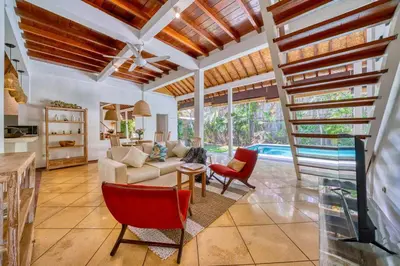 a living room with a couch and a table and chairs at Villa Sabi 3BR in the Heart of Seminyak by Santi Management in Seminyak