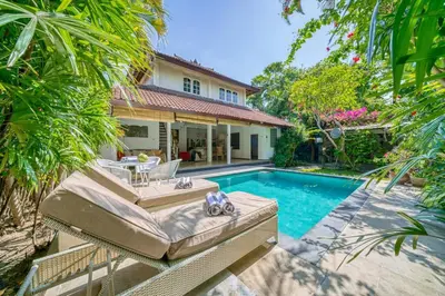 a villa with a swimming pool and a house at Villa Sabi 3BR in the Heart of Seminyak by Santi Management in Seminyak