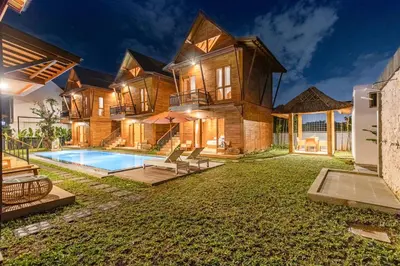 a large house with a swimming pool in the yard at Anartha Resort Jimbaran By Kubu GWK in Jimbaran