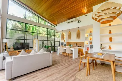 a living room with a couch and a table at Mya Harmony Villas Seminyak in Seminyak