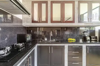 a kitchen with black counter tops and a sink at Villa with private pool in Nusa Dua in Nusa Dua