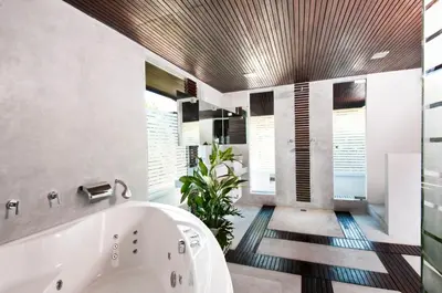 a bathroom with a tub and a plant at 5BR Villa Sabtu - Minggu Villas Seminyak in Seminyak