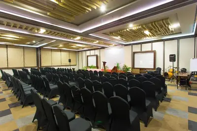 a conference room with chairs and a screen in it at The Lerina Hotel Nusa Dua in Nusa Dua