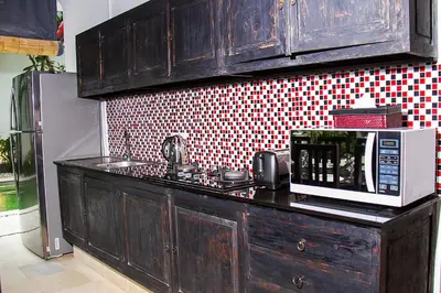 a microwave sitting on a counter in a kitchen at Villa Gardenia - 6 Bedrooms with Pool in Seminyak in Seminyak