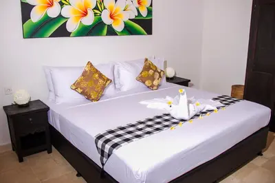 a bedroom with a white bed with flowers on it at Villa Gardenia - 6 Bedrooms with Pool in Seminyak in Seminyak