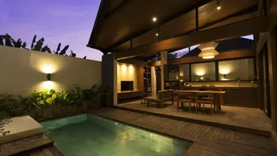 a house with a swimming pool and a dining area at Rarama Teba Villa in Umalas