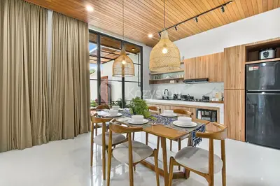 a dining room with a table and chairs in a kitchen at Kanani Villa by Kozystay - Umalas in Seminyak