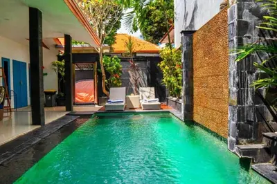 a swimming pool in a house with green water at Altea Villa Legian - 2BR Private Pool, Prime Location & Walk to Beach in Legian