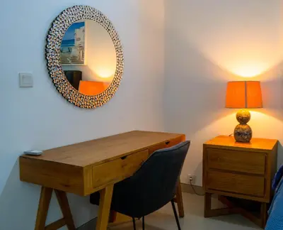 a bedroom with a desk and a mirror and a lamp at Altea Villa Legian - 2BR Private Pool, Prime Location & Walk to Beach in Legian