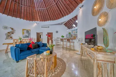 a living room with a blue couch and a tv at Peaceful 2bd Seminyak villa with Private Pool and Garden in Seminyak