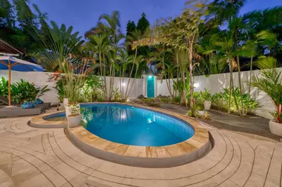a swimming pool in the middle of a courtyard with trees at Peaceful 2bd Seminyak villa with Private Pool and Garden in Seminyak