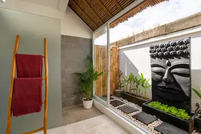 a bathroom with a window with a statue on the wall at Villa Bardo by Pertama Management in Seminyak