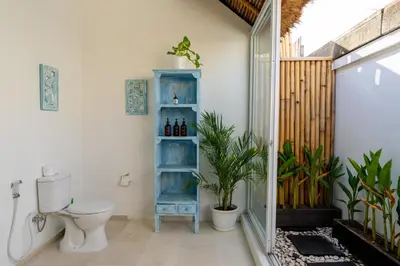 a bathroom with a toilet and a blue shelf at Villa Bardo by Pertama Management in Seminyak