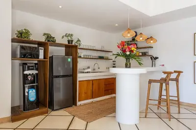 a kitchen with a stainless steel refrigerator and a counter at Villa Dalon by Optimum Bali Villas in Seminyak