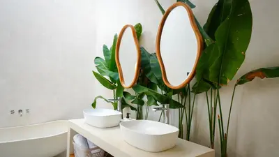 a bathroom with two sinks and a mirror on the wall at Miko Villa Seminyak in Seminyak