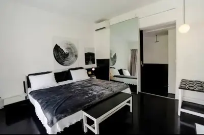 a bedroom with a black and white bed and a stove at Villa bella vista in Seminyak