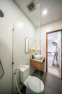 a bathroom with a toilet and a sink at Promo!! New Rosa Villa Muding, Luxury and cozy 3Bedrooms Villa in Heart of Kerobokan with Special Office Room in Kerobokan