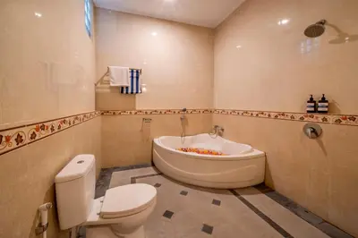 a bathroom with a toilet and a bath tub at Bens Tunjung Villa Two-Bedroom with Private Pool Kuta in Seminyak