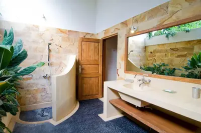 a bathroom with a sink and a large mirror at Villa Kija in Seminyak