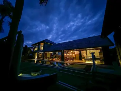 a house at night with the lights on at The Edge by Anima in Kerobokan