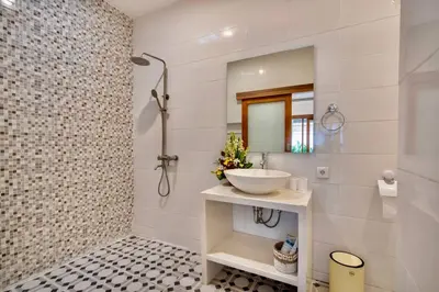 a white bathroom with a sink and a mirror at Bens Mertanadi Villa Two-Bedroom with Private Pool Kuta in Seminyak