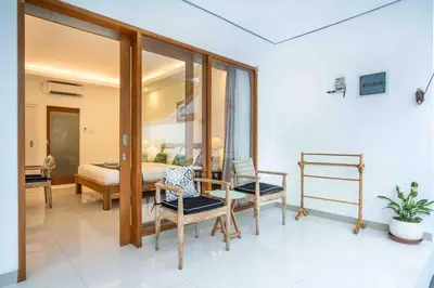 a bedroom with a bed and a table and chairs at Bens Mertanadi Villa Two-Bedroom with Private Pool Kuta in Seminyak