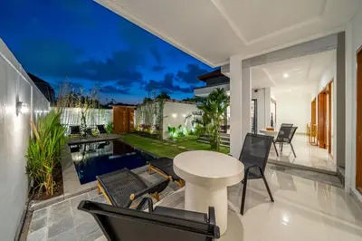 an outdoor patio with a white table and chairs at Viewbali 2- Modern Villa with Stunning Rooftop Views in Kerobokan