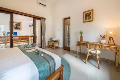 a bedroom with a bed and a desk and a chair at Arts Biyu Villa Two-Bedroom with Private Pool Kuta in Seminyak