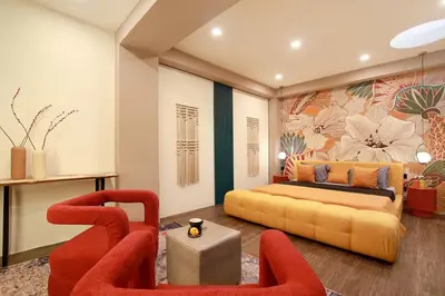 a bedroom with a bed and two chairs at CANGGU BRAND NEW 6Bed VILLA! BEST LOCATION! A STEP-FREE Design Highlight for Families & Friends in Canggu