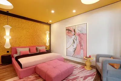 a bedroom with a pink bed and a pink couch at CANGGU BRAND NEW 6Bed VILLA! BEST LOCATION! A STEP-FREE Design Highlight for Families & Friends in Canggu