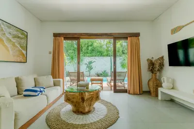 a living room with a couch and a table at Baliterraneo Boutique Resort Seminyak in Seminyak