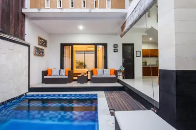 a swimming pool in the middle of a house at 8-BR Private Pool Legian Villa 5-min Walk to Beach and Shops in Seminyak