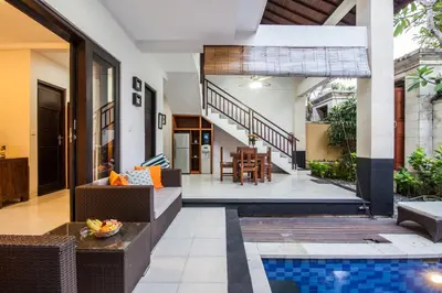 an outdoor living room with a pool in a house at 8-BR Private Pool Legian Villa 5-min Walk to Beach and Shops in Seminyak