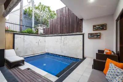 a swimming pool in the middle of a house at 8-BR Private Pool Legian Villa 5-min Walk to Beach and Shops in Seminyak