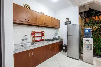 a kitchen with a sink and a refrigerator at 8-BR Private Pool Legian Villa 5-min Walk to Beach and Shops in Seminyak