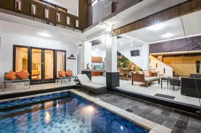 an indoor pool in a house with a living room at 7-BR Private Pool Legian Villa 5-Min Walk to Beach and Shops Bali in Seminyak