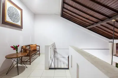 a hallway with white walls and a wooden ceiling at 7-BR Private Pool Legian Villa 5-Min Walk to Beach and Shops Bali in Seminyak