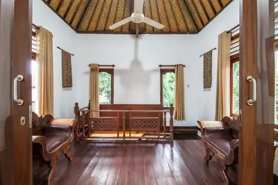 a living room with a ceiling fan and chairs at 6-BR Garden Legian Villa 5-Min Walk to Beach and Shops Bali in Seminyak
