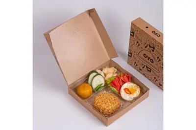 a box filled with different types of food at Townhouse Oak Denpasar at Mahendradatta in Denpasar