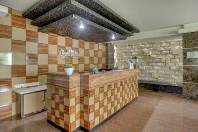 a kitchen with a counter with a stone wall at Townhouse Oak Denpasar at Mahendradatta in Denpasar