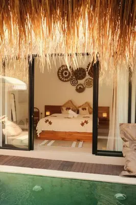 a bedroom with a bed and a swimming pool at Amethyst Villa Seminyak in Seminyak