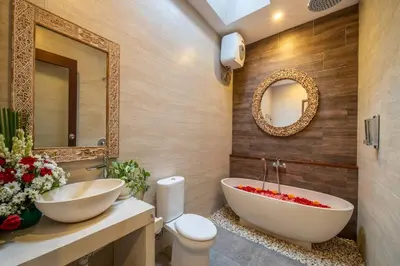 a bathroom with a large white tub and a sink at Arts Cherry Villa Satu Two-Bedroom with Private Pool Kuta in Kerobokan