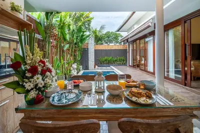 a table with food on it in a house at Arts Cherry Villa Satu Two-Bedroom with Private Pool Kuta in Kerobokan
